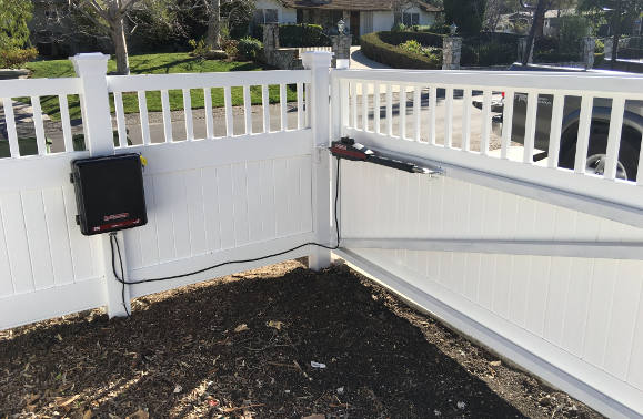 Automated vinyl gate with picket accent, on steel frames